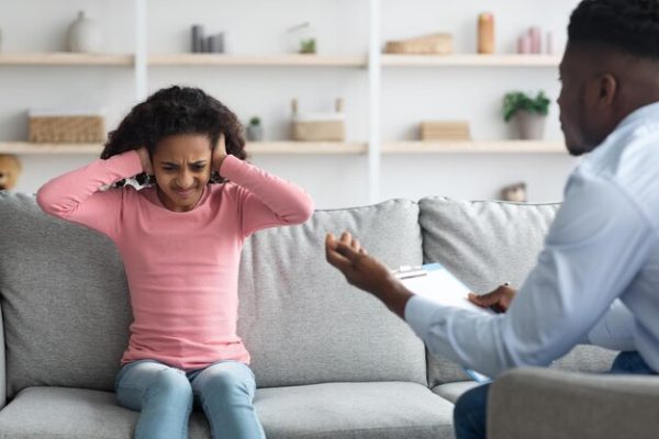 irritated-girl-covering-her-ears-while-having-conversation-with-psychotherapist_116547-19722